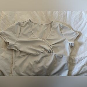 Three white crop tops all different designs